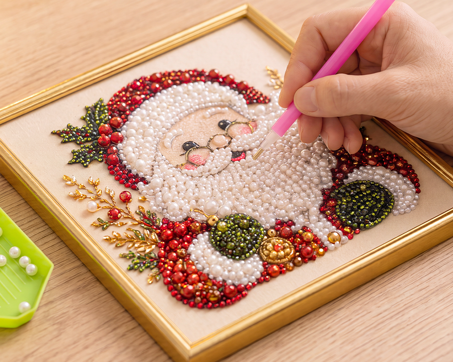 Placing pearls onto the Santa Christmas artwork